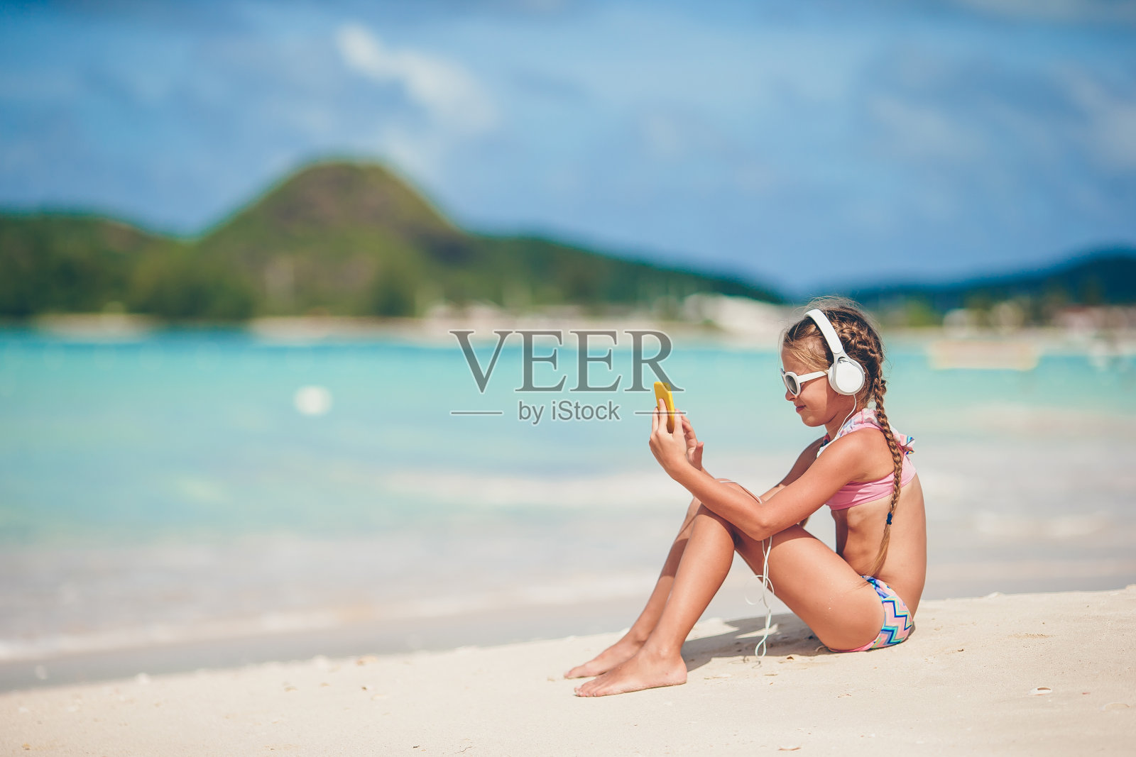 可爱活泼的小女孩在暑假的海滩上照片摄影图片