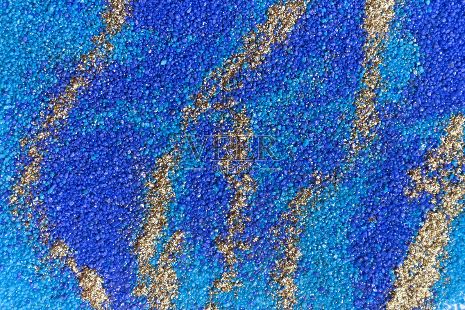 层状彩色沙纹。大理石风格背景。蓝色和金色粉末纹理。照片摄影图片