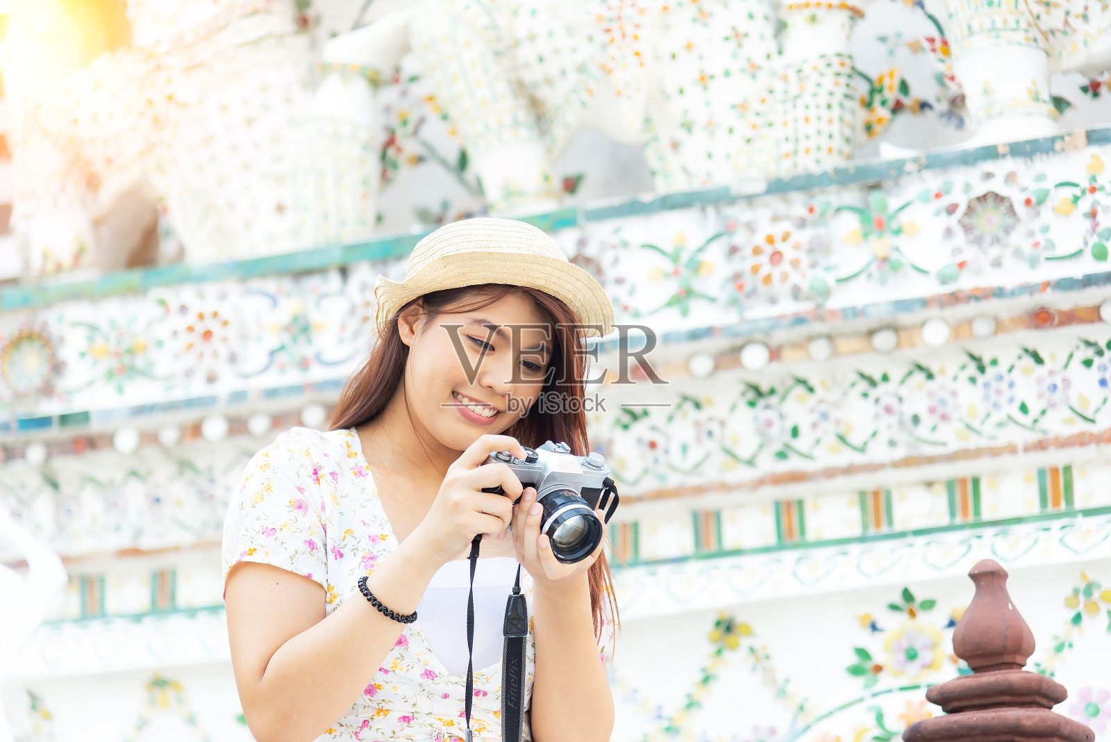 年轻的亚洲女性游客在Wat Arun Ratchawararam旅游，其中一个著名的地方在曼谷，泰国是受欢迎的旅游景点附近的Wat照片摄影图片