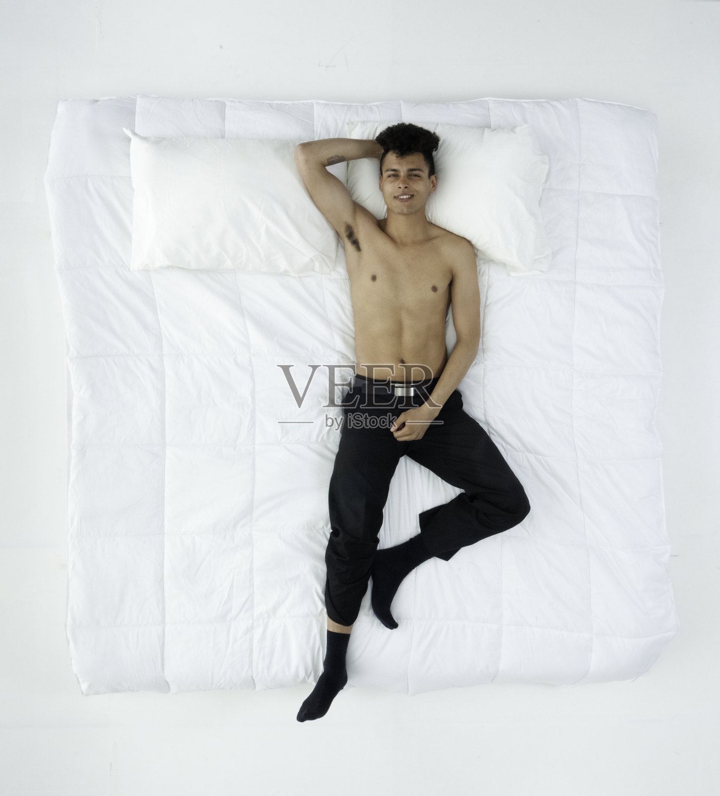赤裸上身的男人躺在床上照片摄影图片