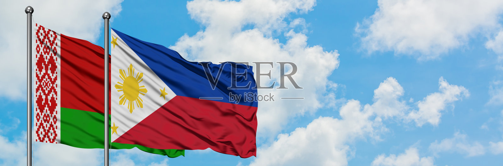 白俄罗斯和菲律宾的国旗迎风飘扬，对抗着白色多云的蓝天。外交理念，国际关系。照片摄影图片