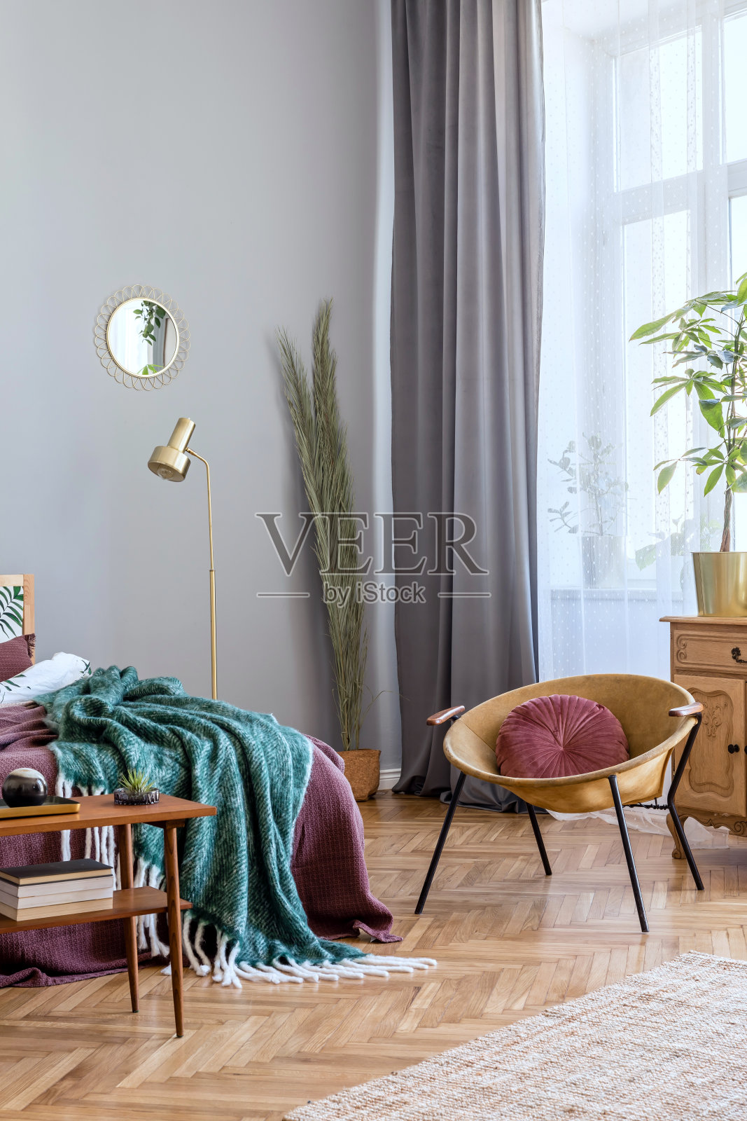 时尚豪华的室内设计家具，蜜黄色的扶手椅，灰色的流苏，金色的灯和优雅的配饰。漂亮的床单、毯子和枕头。舒适的家居装饰。照片摄影图片