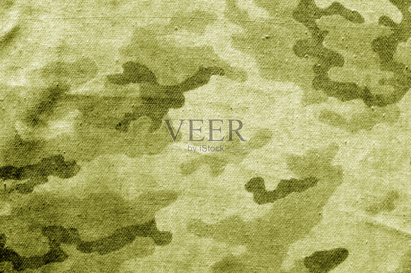 黄色调的脏迷彩布。照片摄影图片