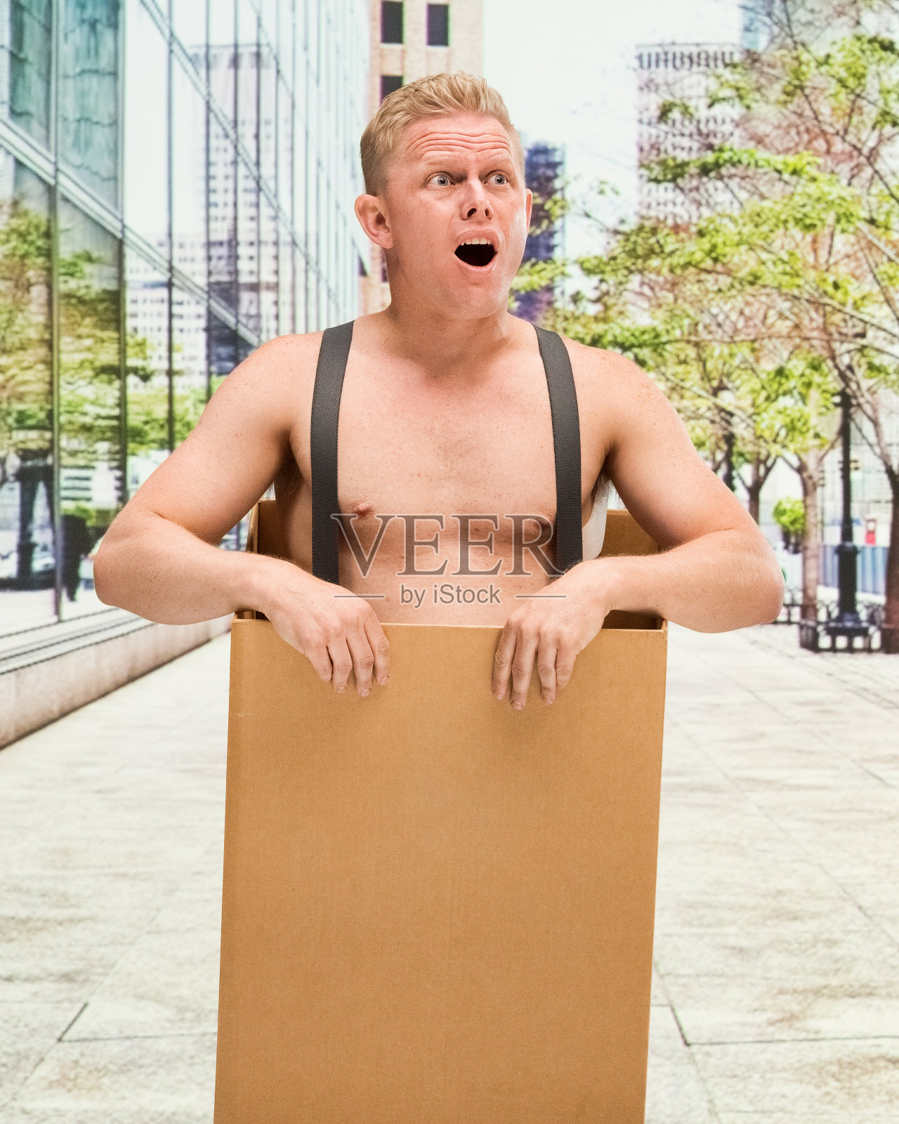 穷男人在箱子赤膊震惊照片摄影图片