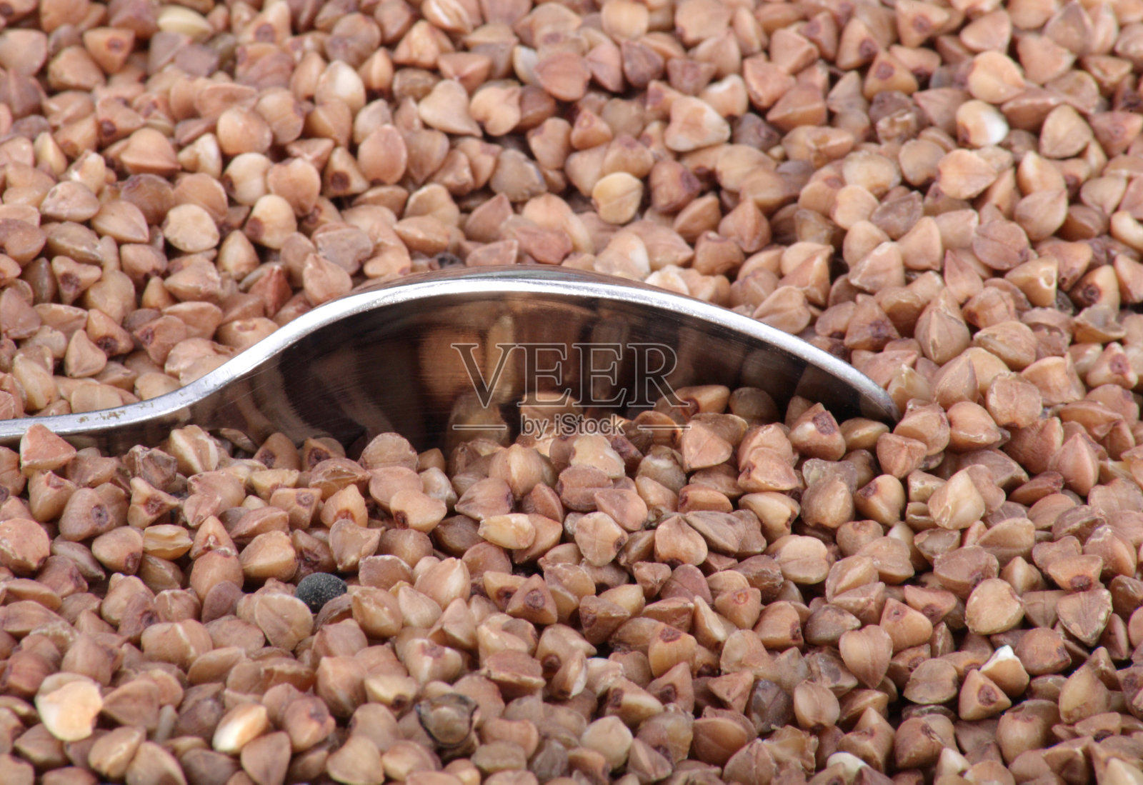 荞麦背景和一茶匙照片摄影图片