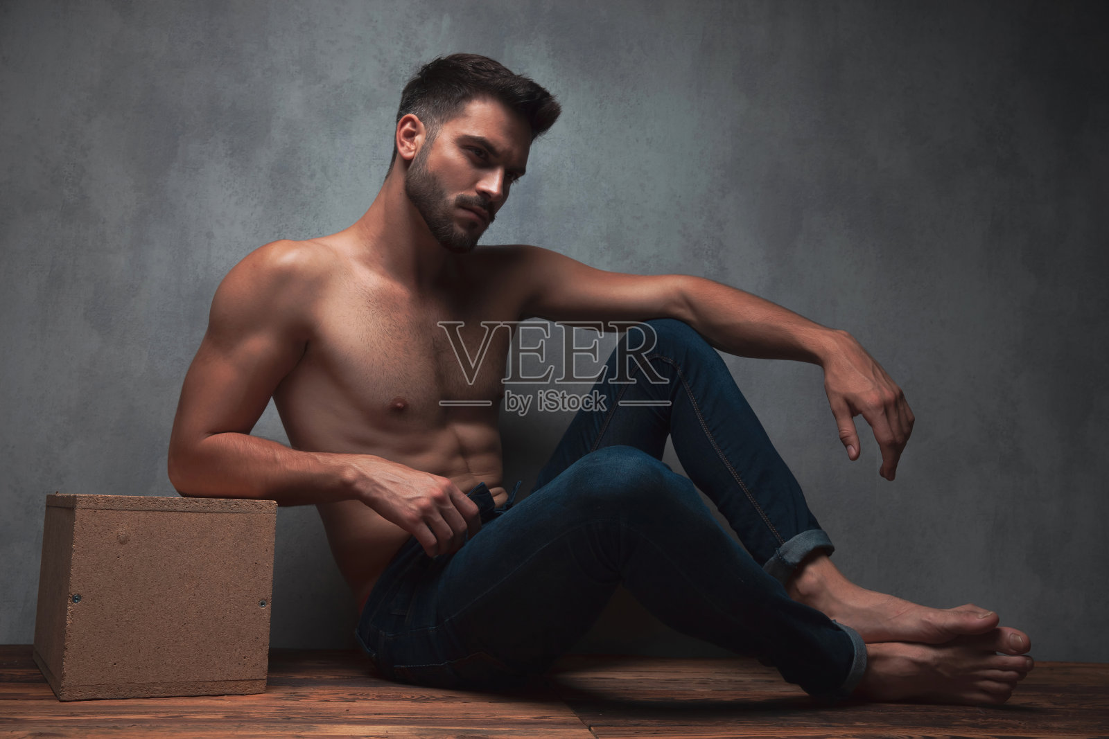 忧心忡忡的人把胳膊放在膝盖上，皱着眉头照片摄影图片