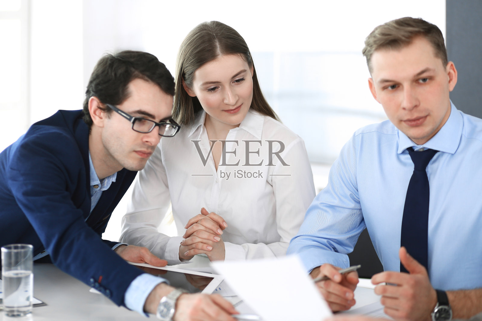 一群商务人士在现代办公室开会讨论问题。经理在谈判或头脑风暴。团队合作，伙伴关系和经营理念照片摄影图片