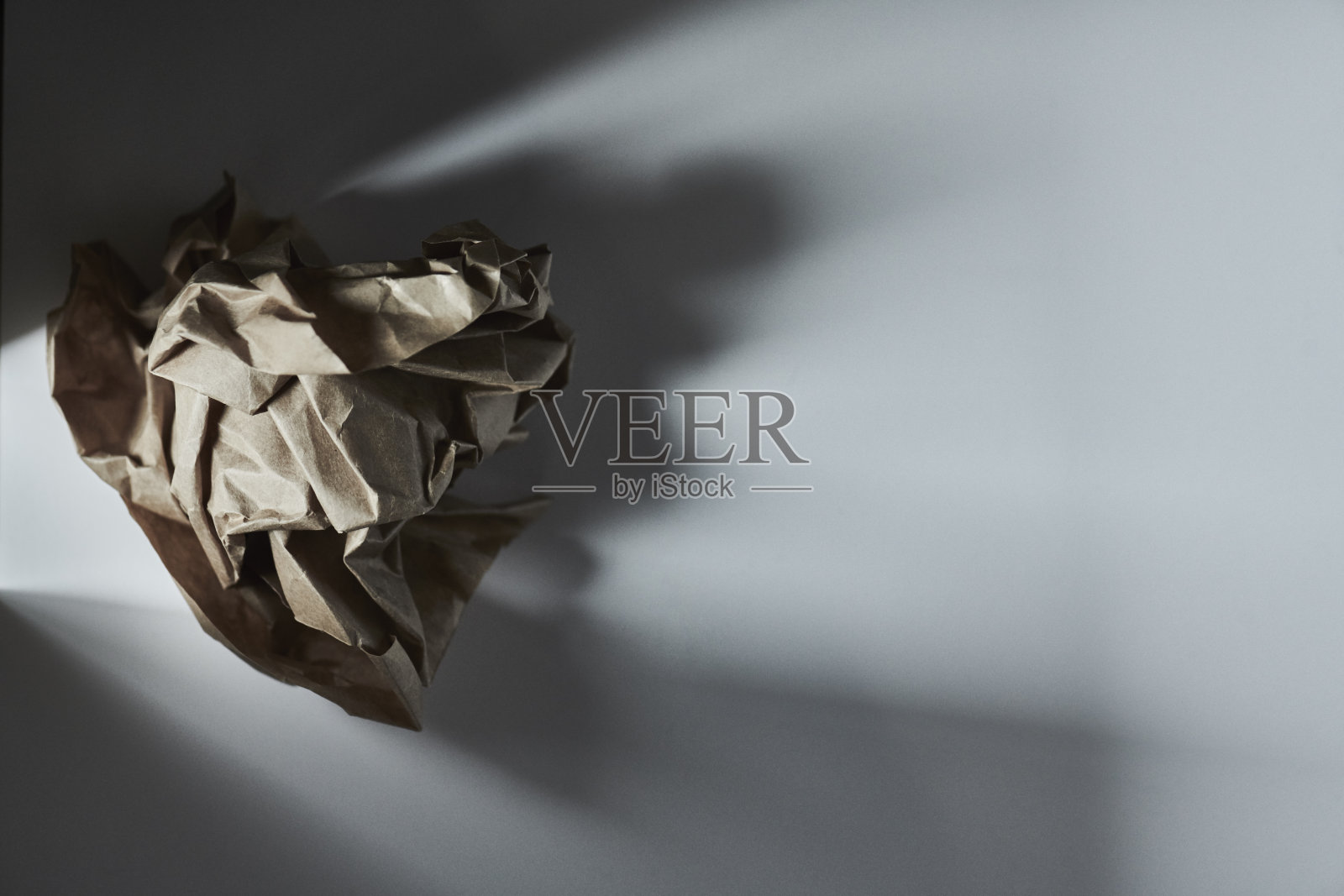 白色桌子上的皱巴巴的牛皮纸照片摄影图片