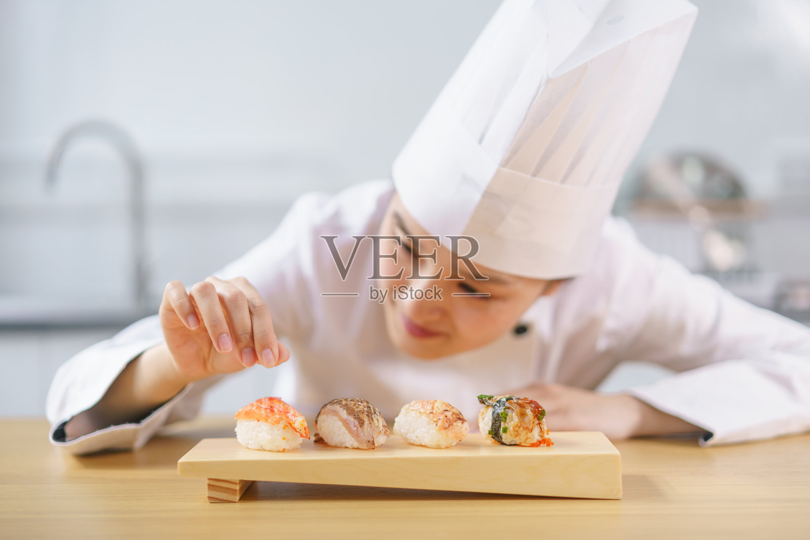 做寿司的女厨师照片摄影图片
