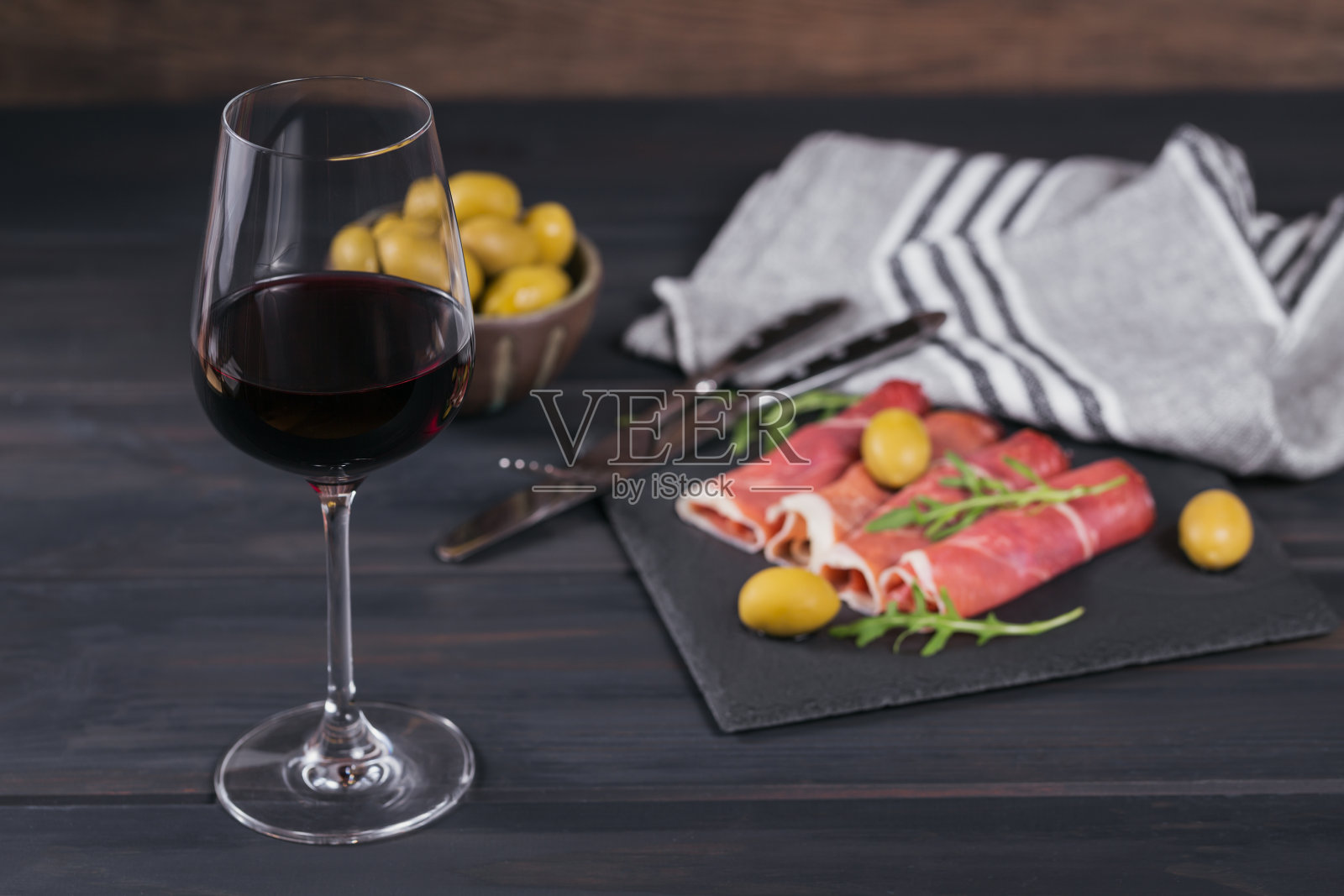 黑石制大浅盘，配上腌火腿片或西班牙塞拉诺火腿或意大利火腿照片摄影图片