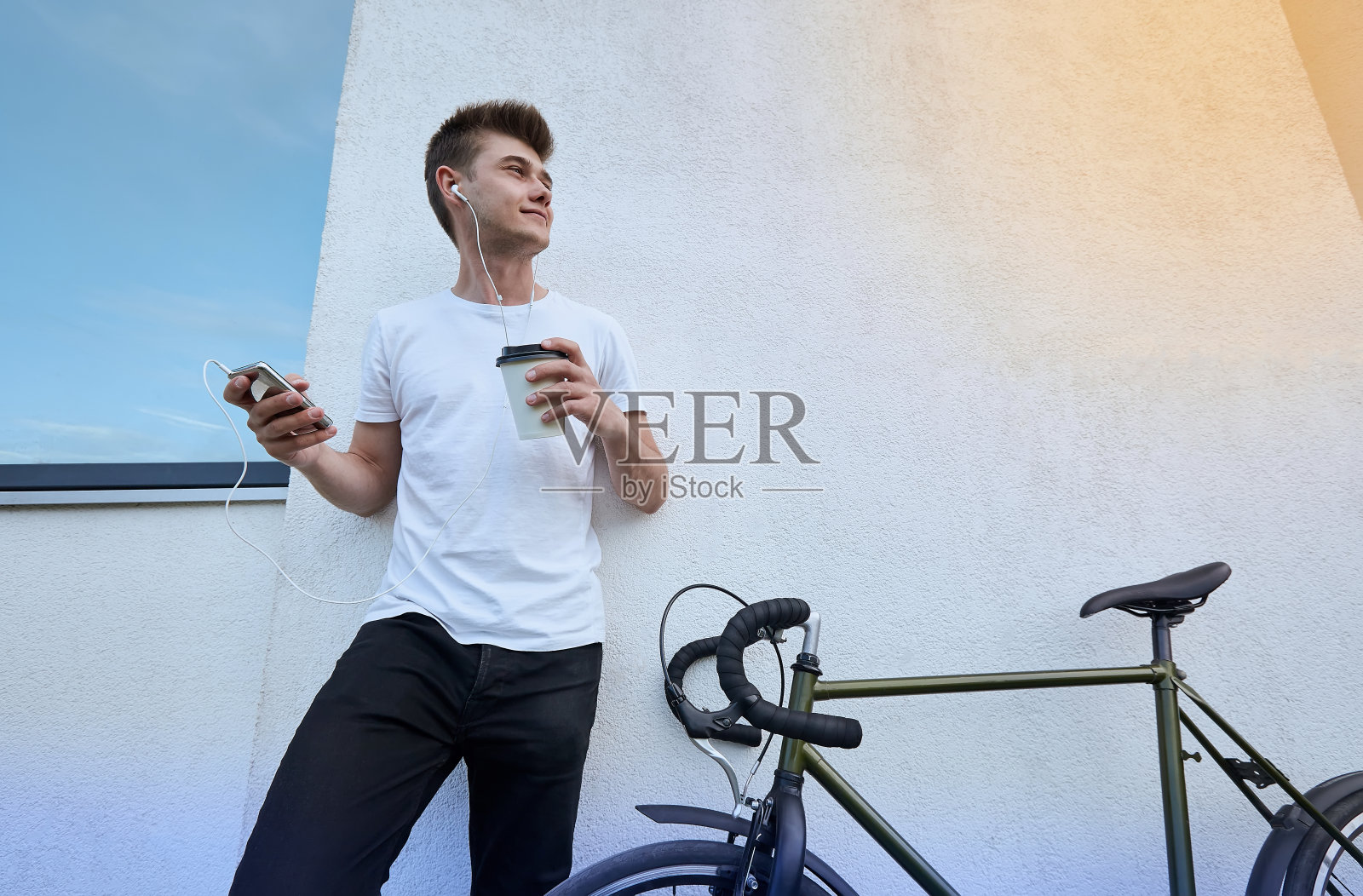 帅气的潮人与自行车在城市摆姿势。照片摄影图片