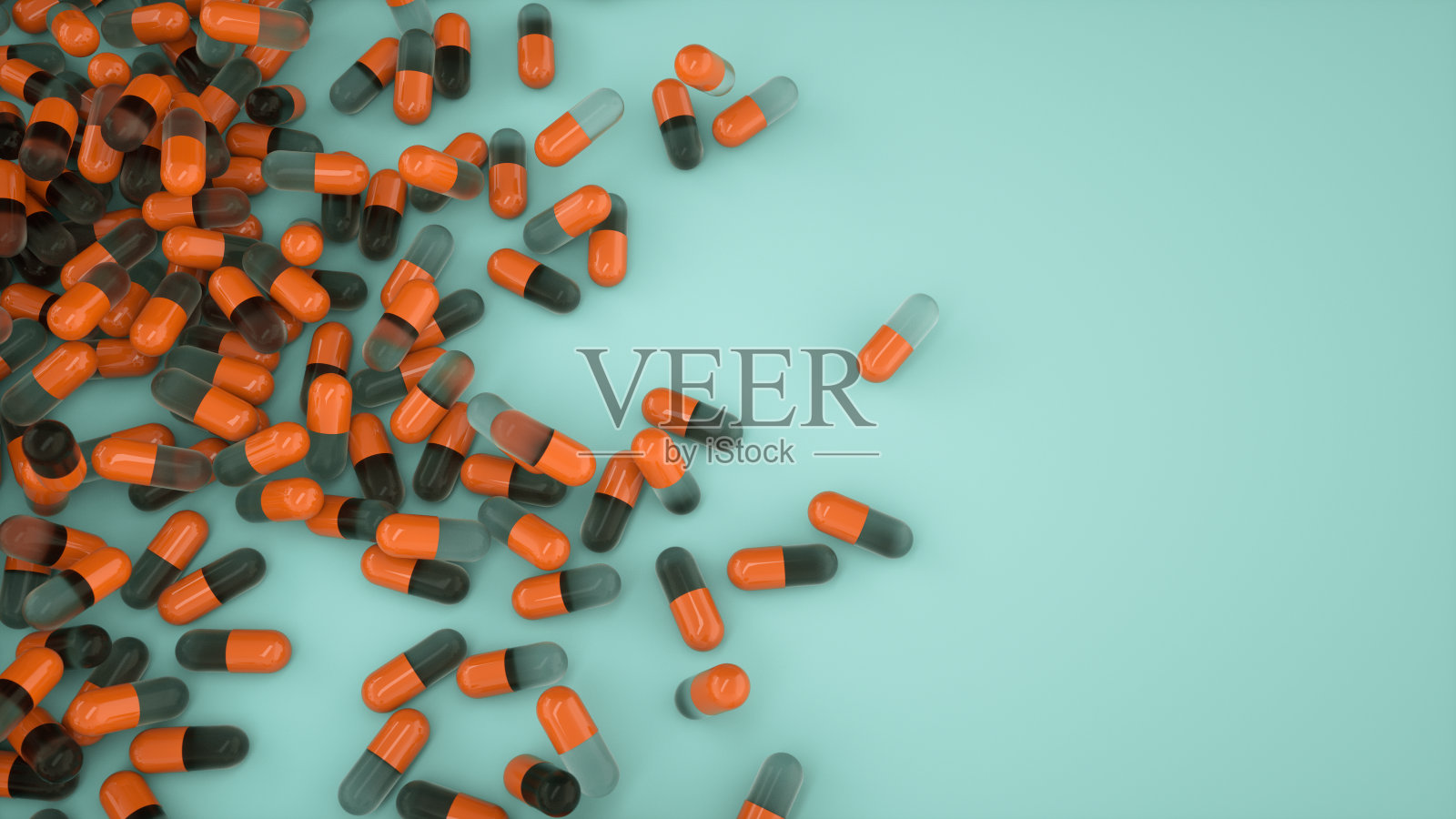 一堆橙色的胶囊药丸在蓝绿色的背景俯视图。医学健康药学药理学概念照片摄影图片