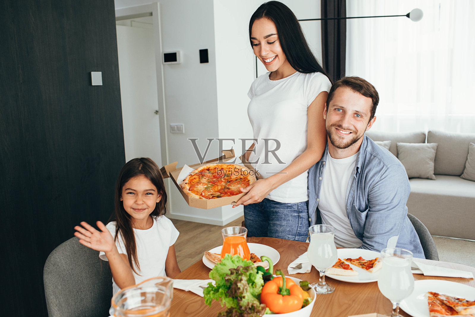 幸福多民族家庭，母女共进晚餐。和家人一起吃美味的披萨照片摄影图片