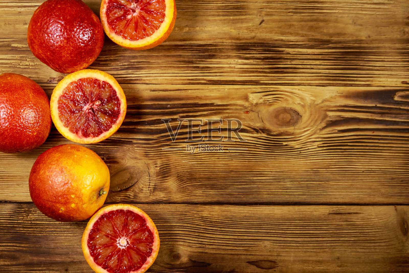 木桌上放着红色的血橙。俯视图照片摄影图片