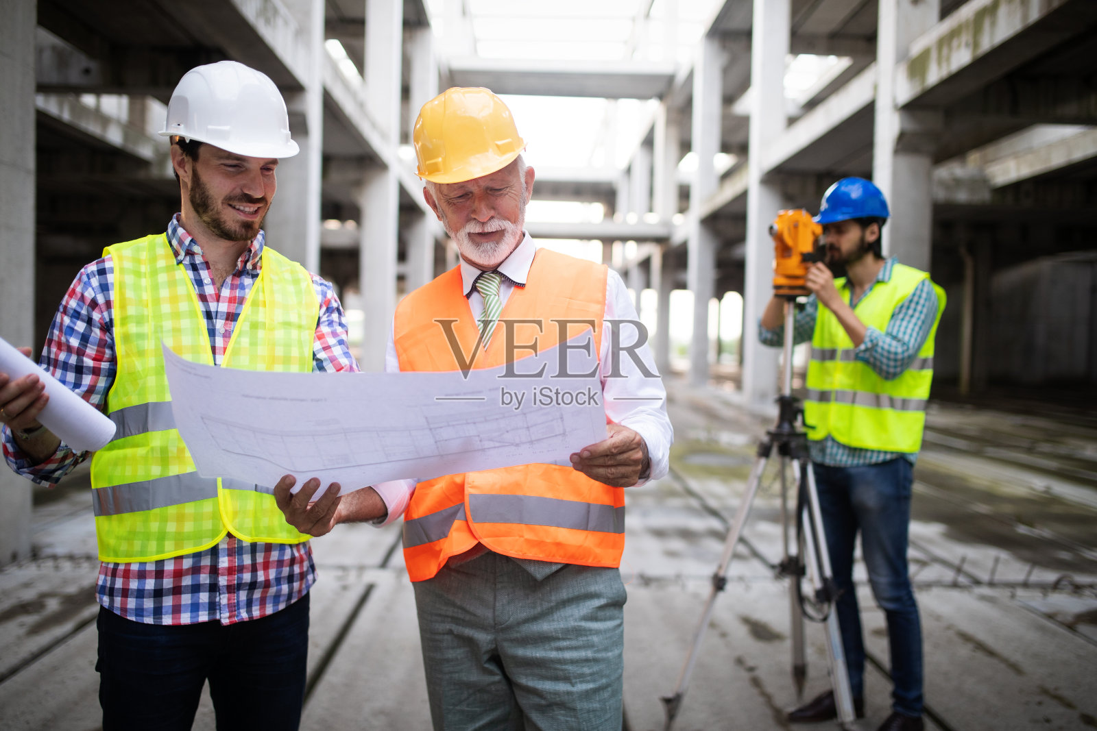 工程师、工头和工人在建筑工地讨论照片摄影图片