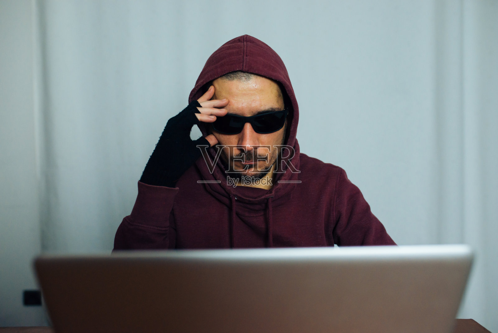 带着笔记本的连帽衫男照片摄影图片