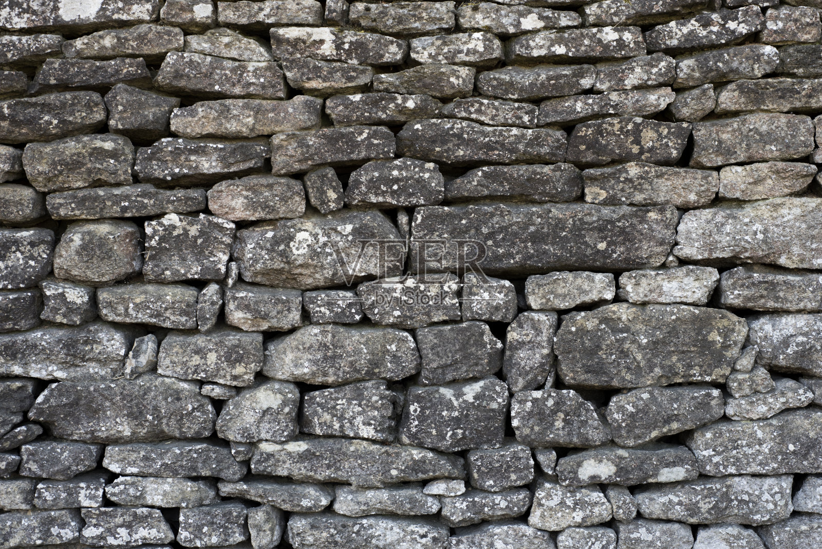 背景是一堵古老干燥的石墙照片摄影图片