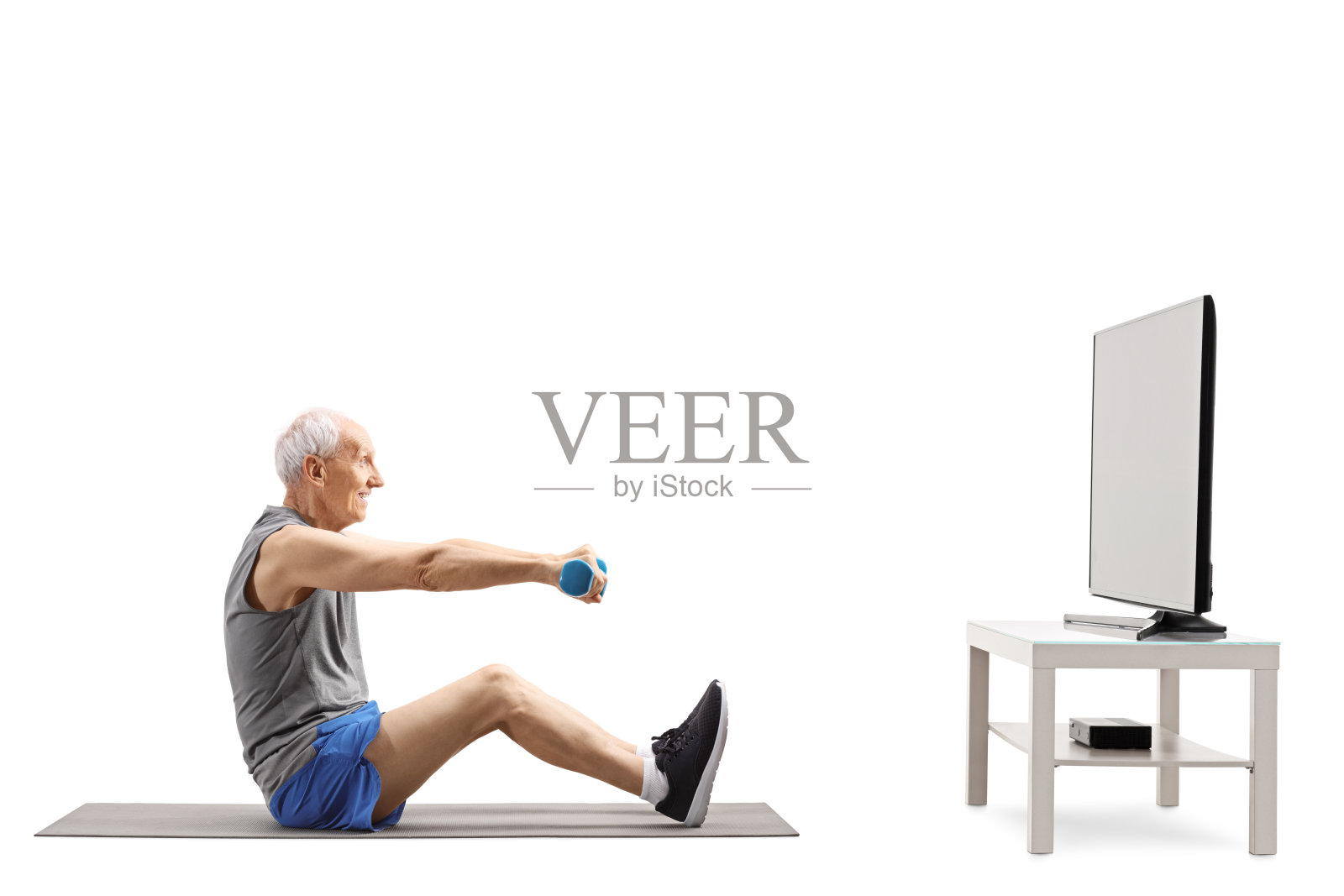 一位老人在电视机前举着哑铃锻炼身体照片摄影图片