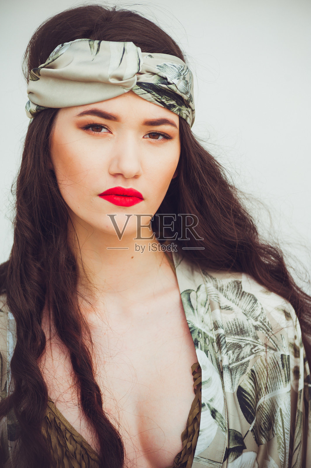 一个年轻漂亮的女人，穿着沙滩装，头上戴着缎带照片摄影图片