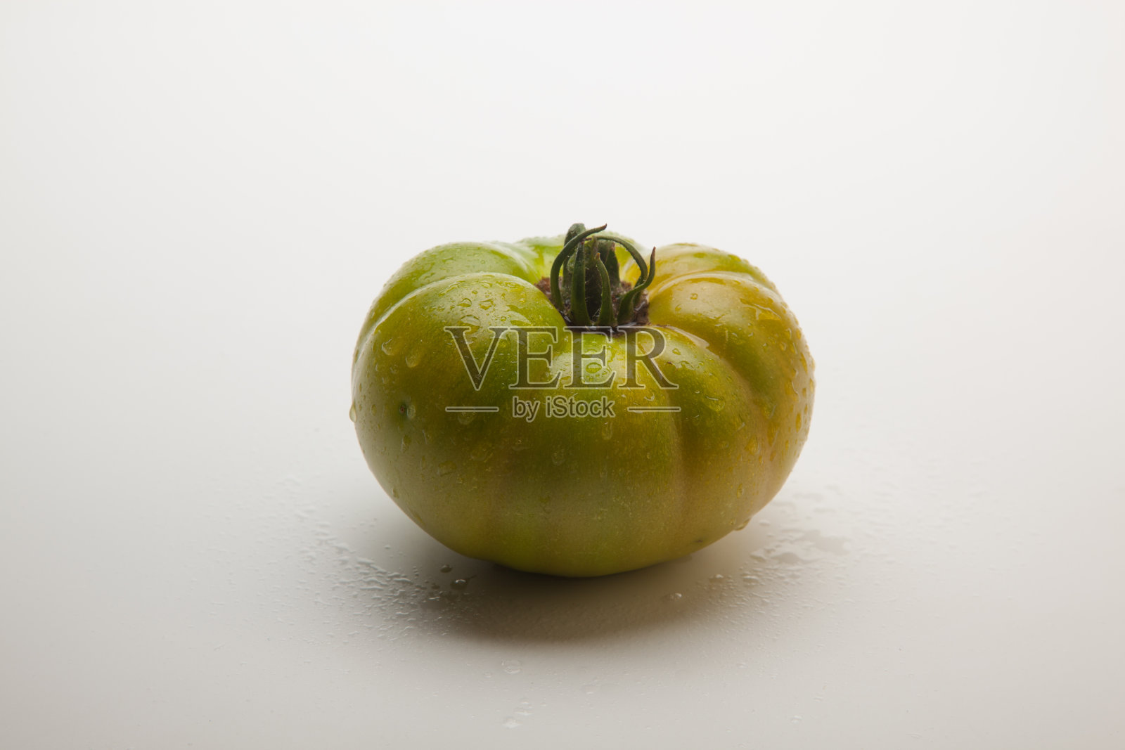 平原背景上的生态绿色番茄。照片摄影图片