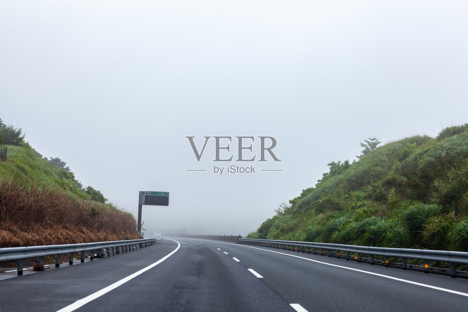 开车在高速公路上，在穆迪雾蒙蒙的风景。照片摄影图片