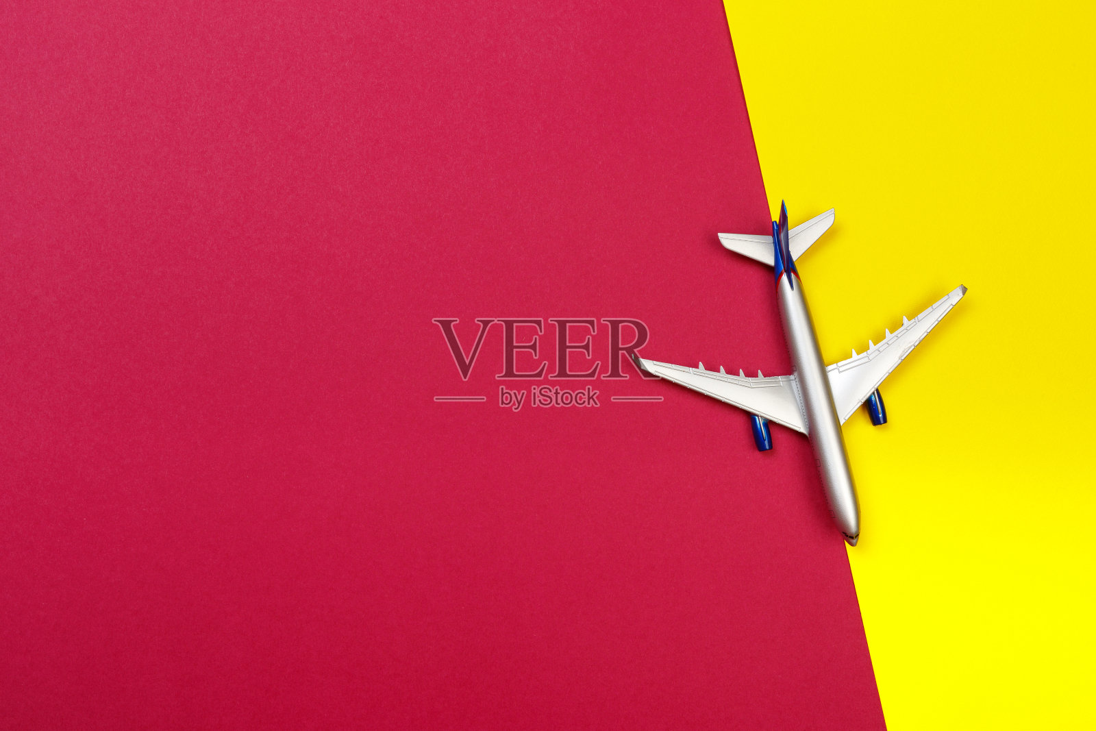 俯视图照片上的玩具飞机的彩色背景。旅游概念-形象照片摄影图片