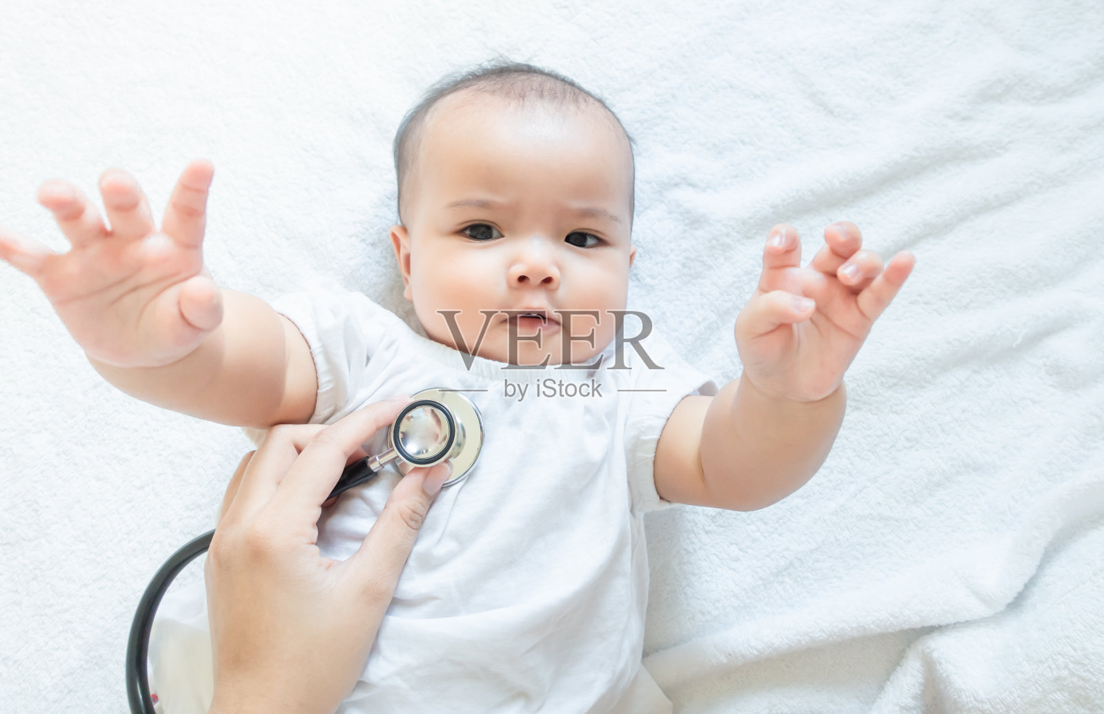 亚洲女婴和听诊器白色毛巾背景照片摄影图片