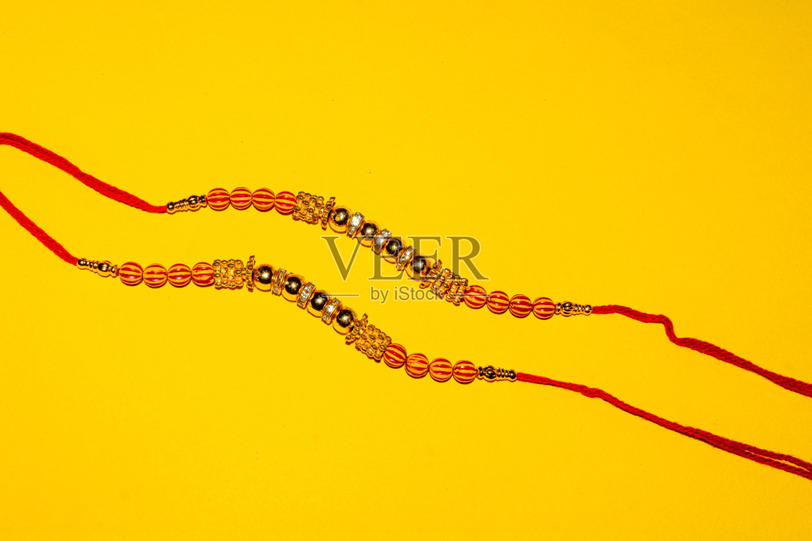 印度传统节日Raksha Bandhan，黄色背景上优雅的Rakhi。照片摄影图片