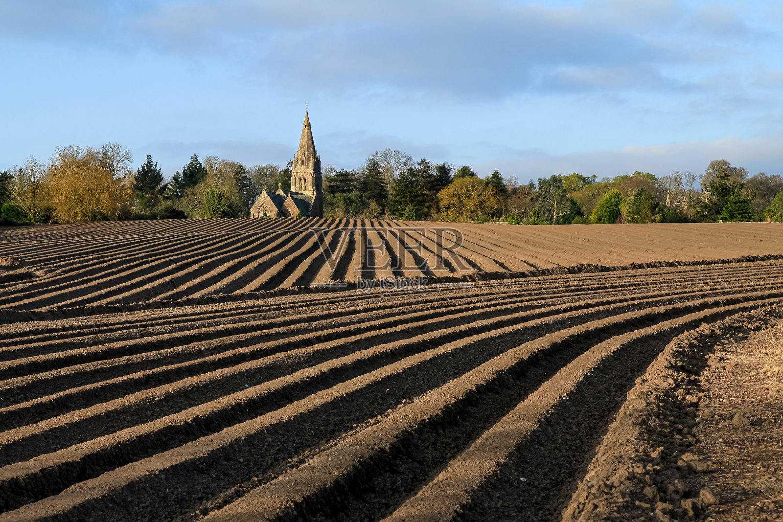 在康沃尔东南部的威尔考夫附近，可以看到教堂和尖顶的耕地照片摄影图片