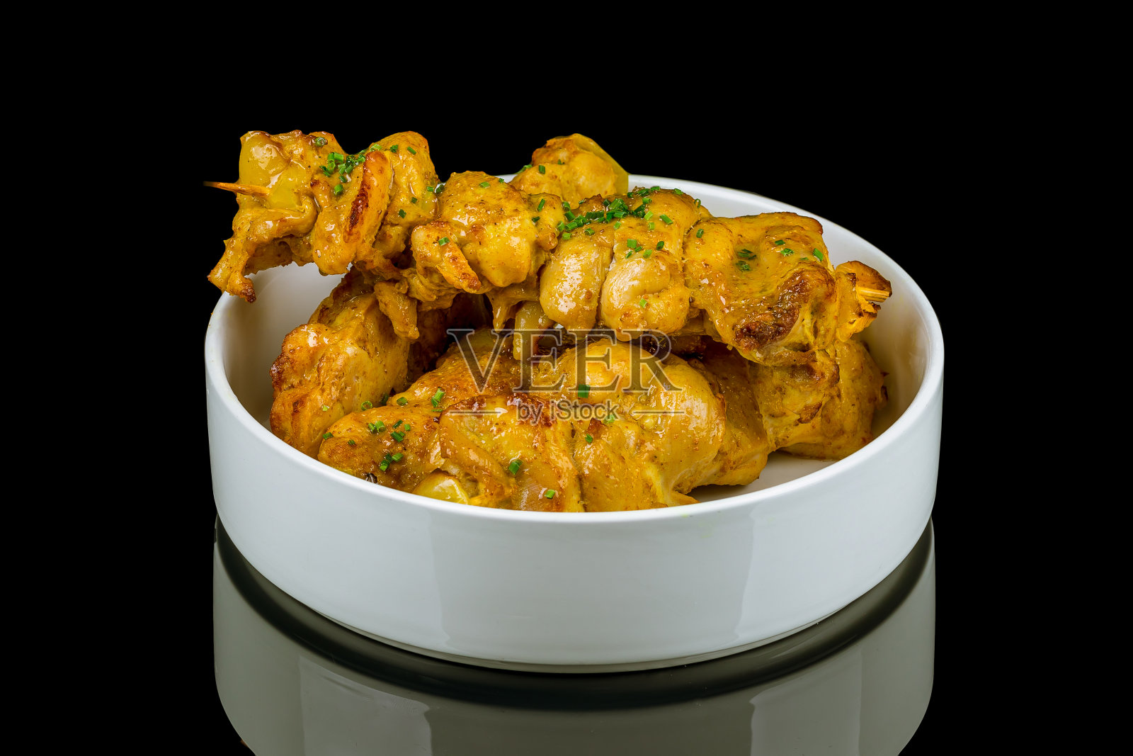 烤鸡肉串在黑色玻璃上，有反光照片摄影图片