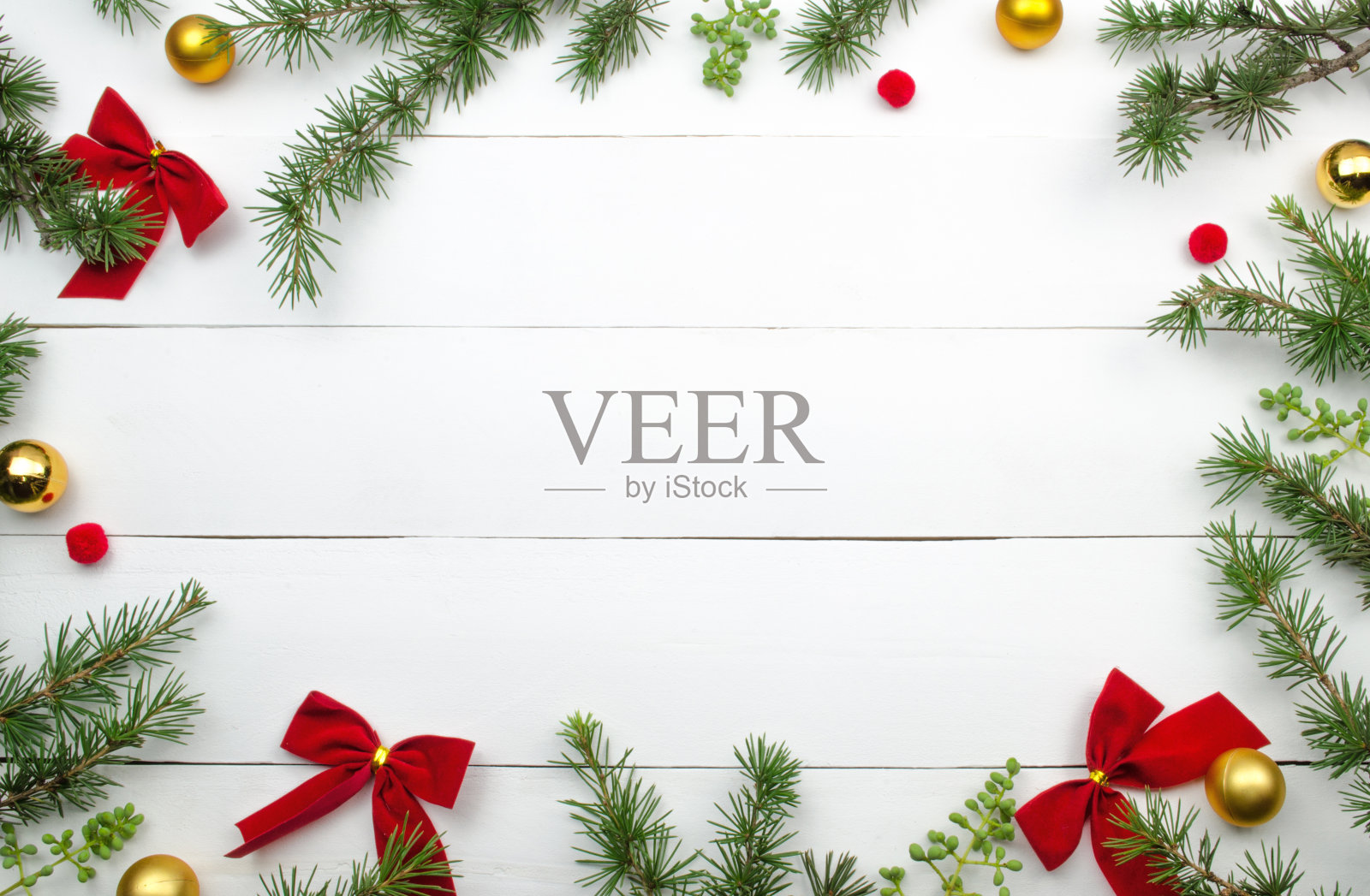 创意的圣诞布局。冷杉枝，红丝带和金球。照片摄影图片