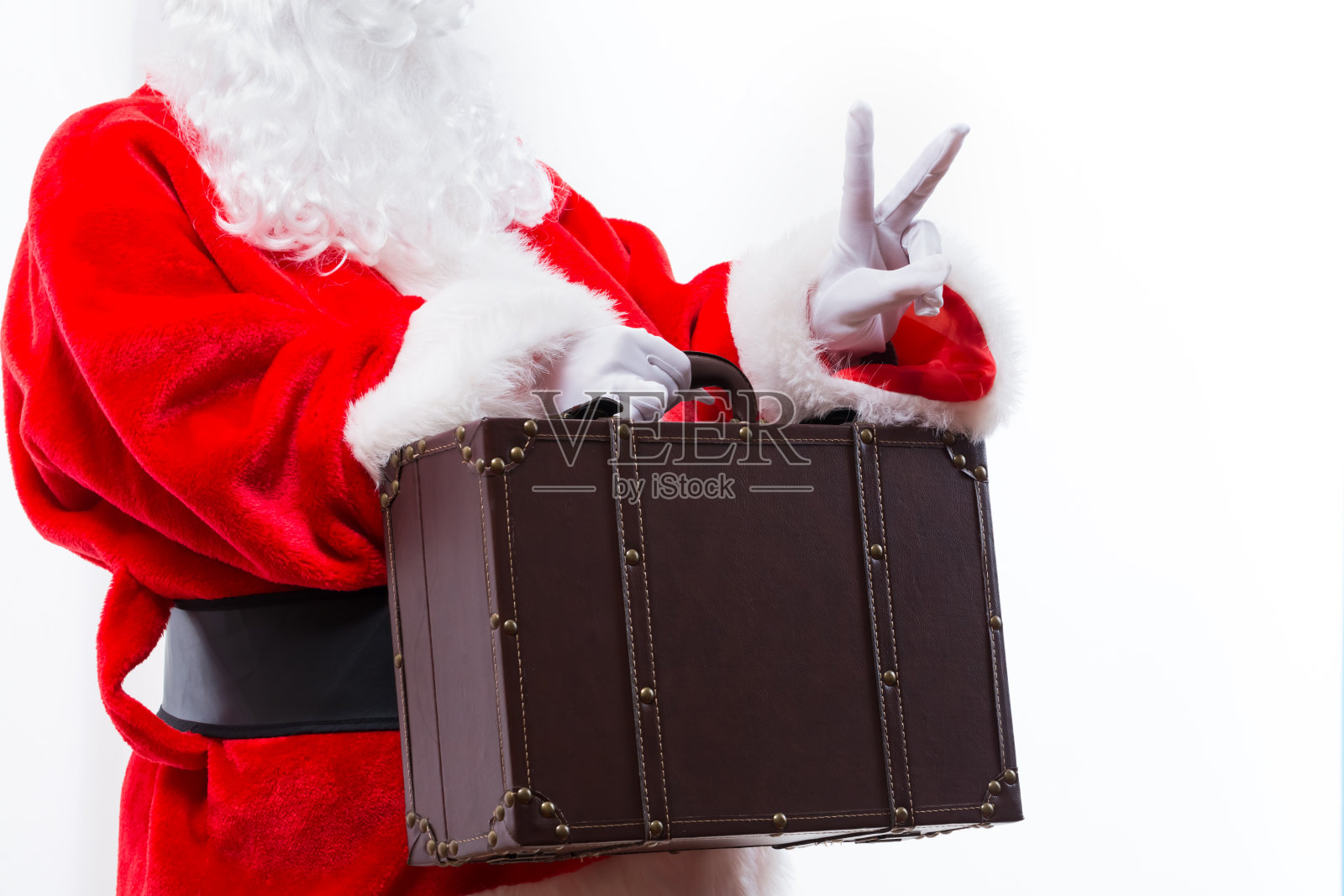 拿着皮箱的圣诞老人照片摄影图片