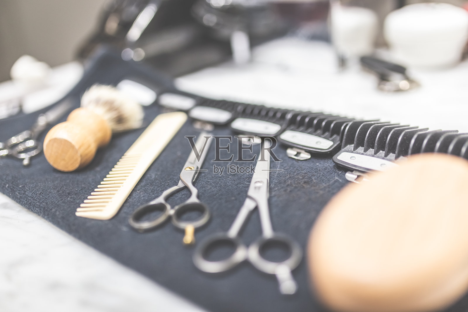 桌上的毛巾上放着剃须和理发设备。照片摄影图片