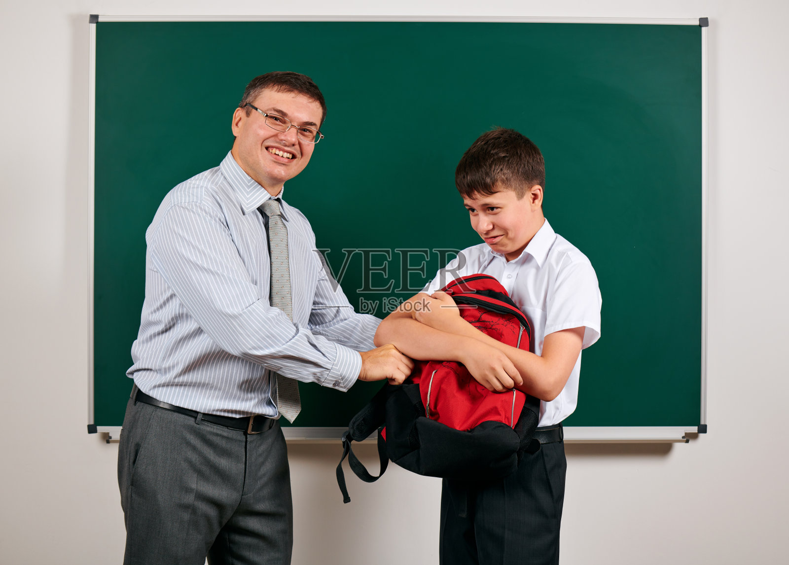 一个教师和学生在黑板上玩的肖像背景-回到学校和教育的概念照片摄影图片
