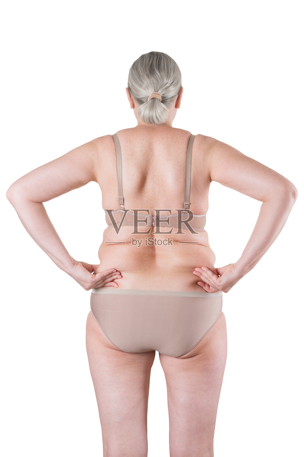 老胖女人孤立在白色的背景，超重的背部与皱褶的皮肤照片摄影图片