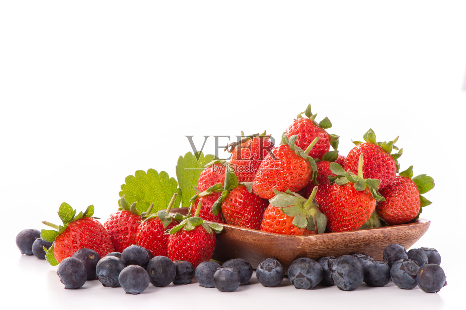 一碗美丽和美味的草莓和蓝莓孤立在白色的背景。照片摄影图片