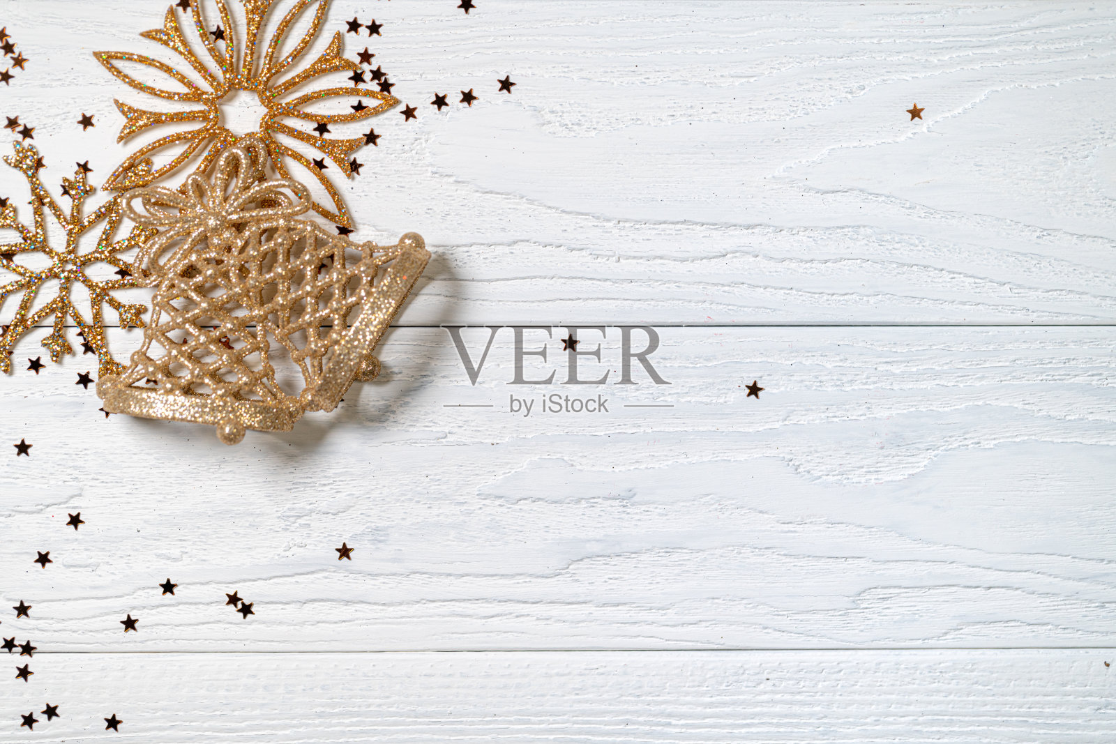 圣诞节的背景。白色木地板上的金色圣诞装饰。照片摄影图片