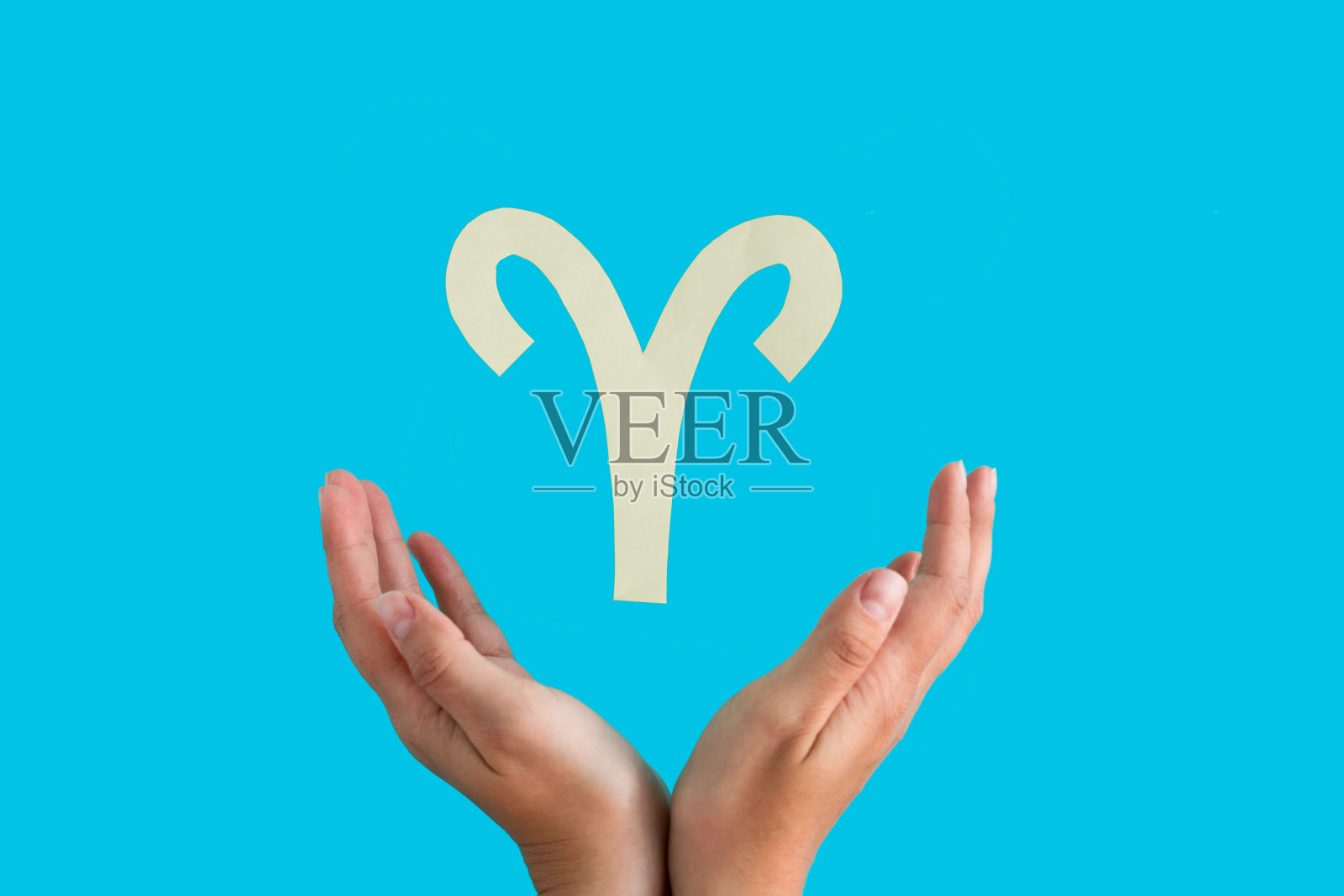 星座悬挂在女性的手在蓝色背景照片摄影图片