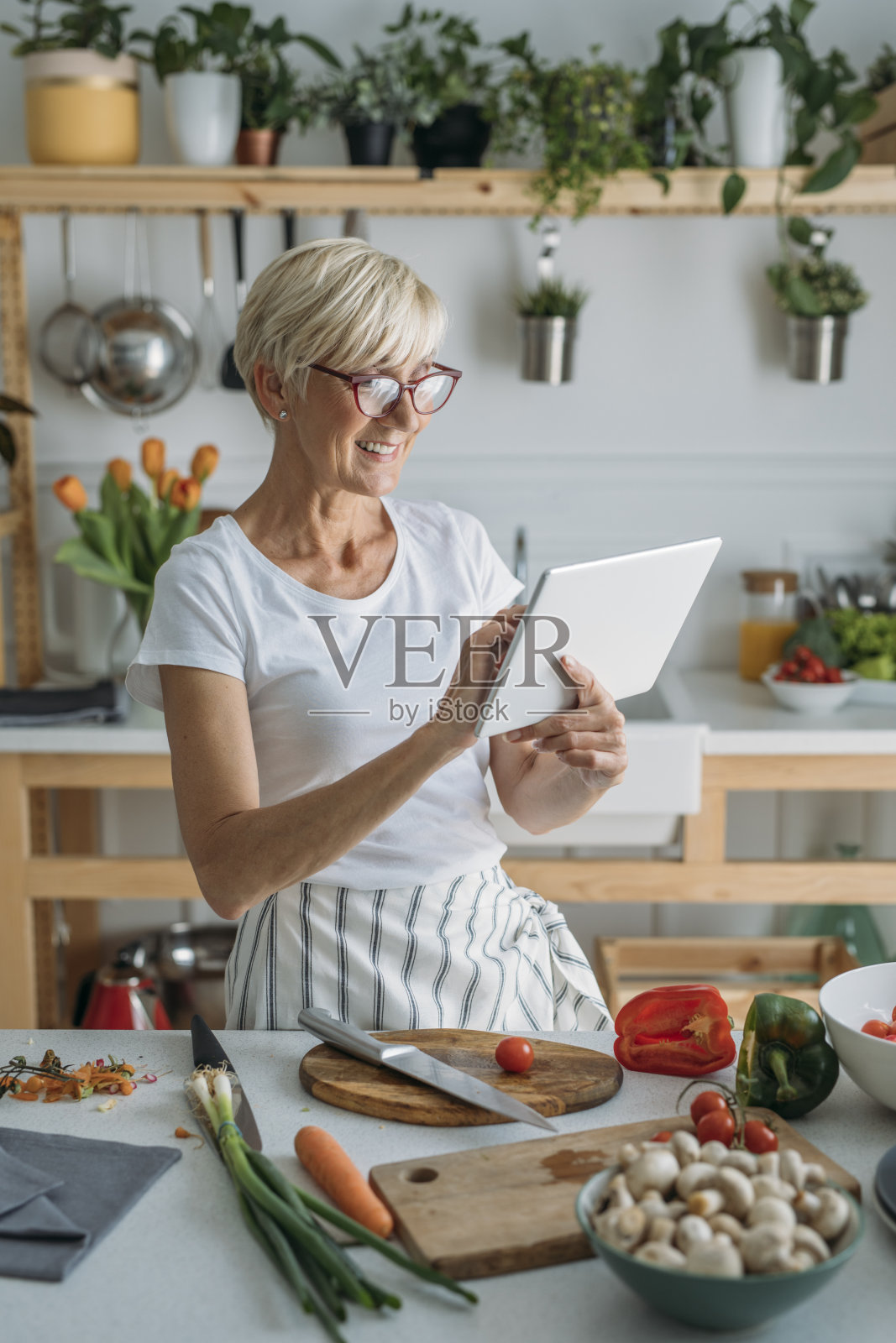 女性在厨房使用平板电脑照片摄影图片