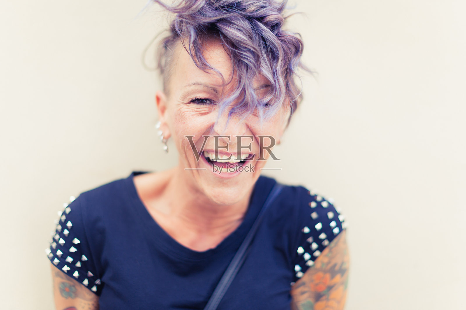 一个现代意大利女人的肖像，倚靠在黄色的墙上照片摄影图片