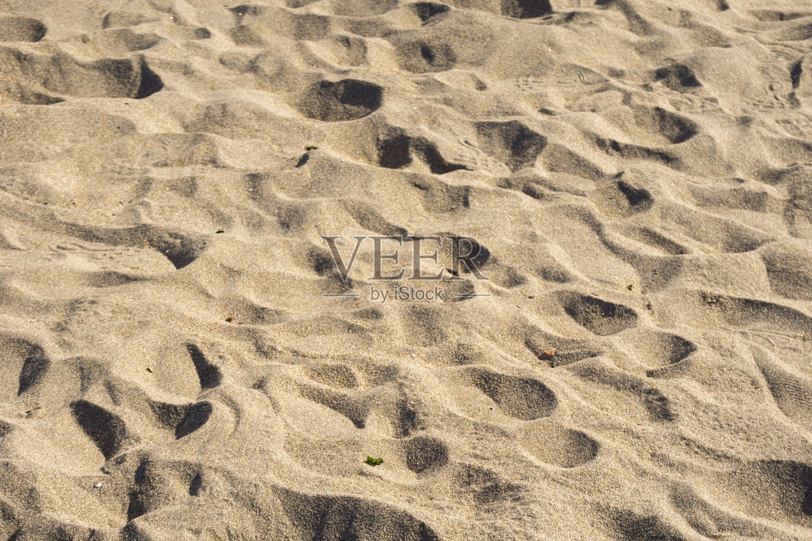 沙滩上的脚印是沙滩的背景照片摄影图片