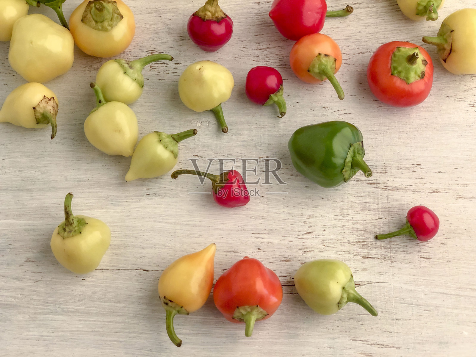 木桌上放着五颜六色的新鲜辣椒照片摄影图片