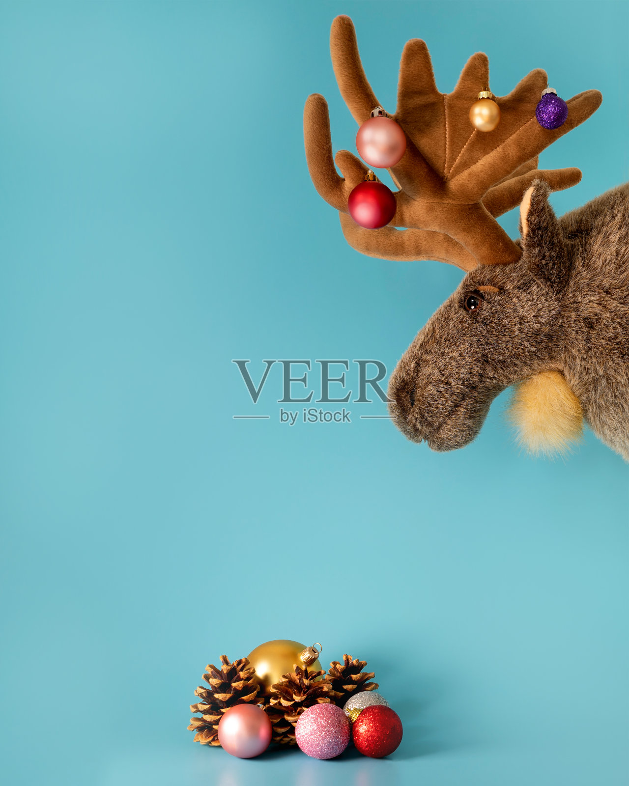 带着圣诞树装饰品的驼鹿。照片摄影图片