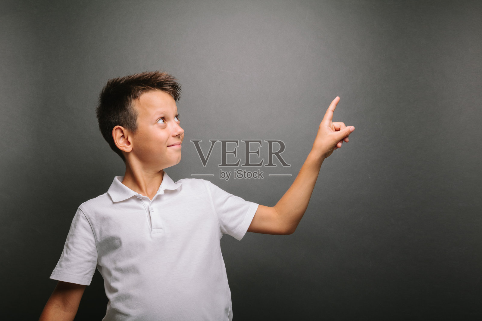 一个模特男孩在灰色背景下摆姿势照片摄影图片