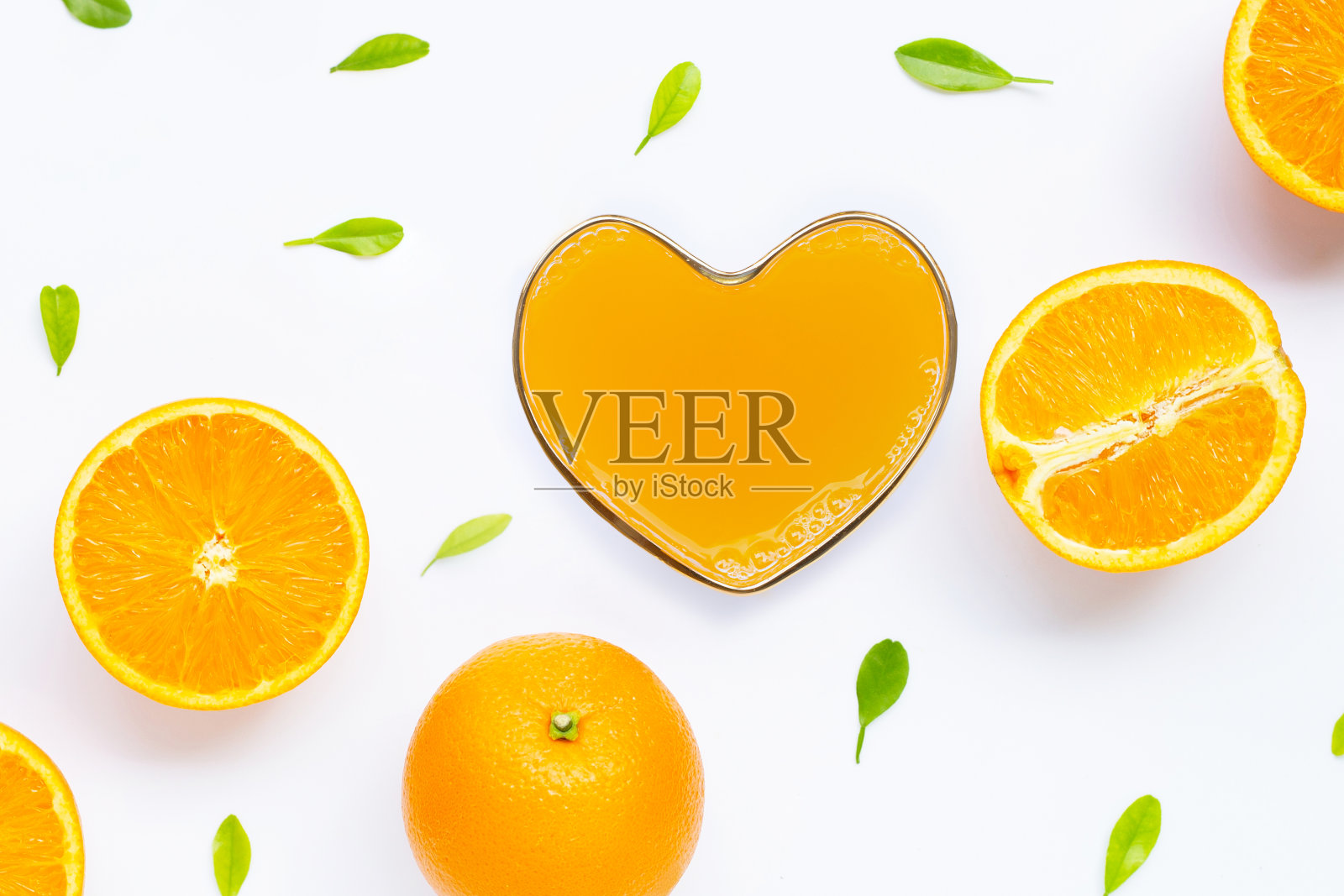 心型杯的新鲜橙汁与橙水果在白色的背景。照片摄影图片