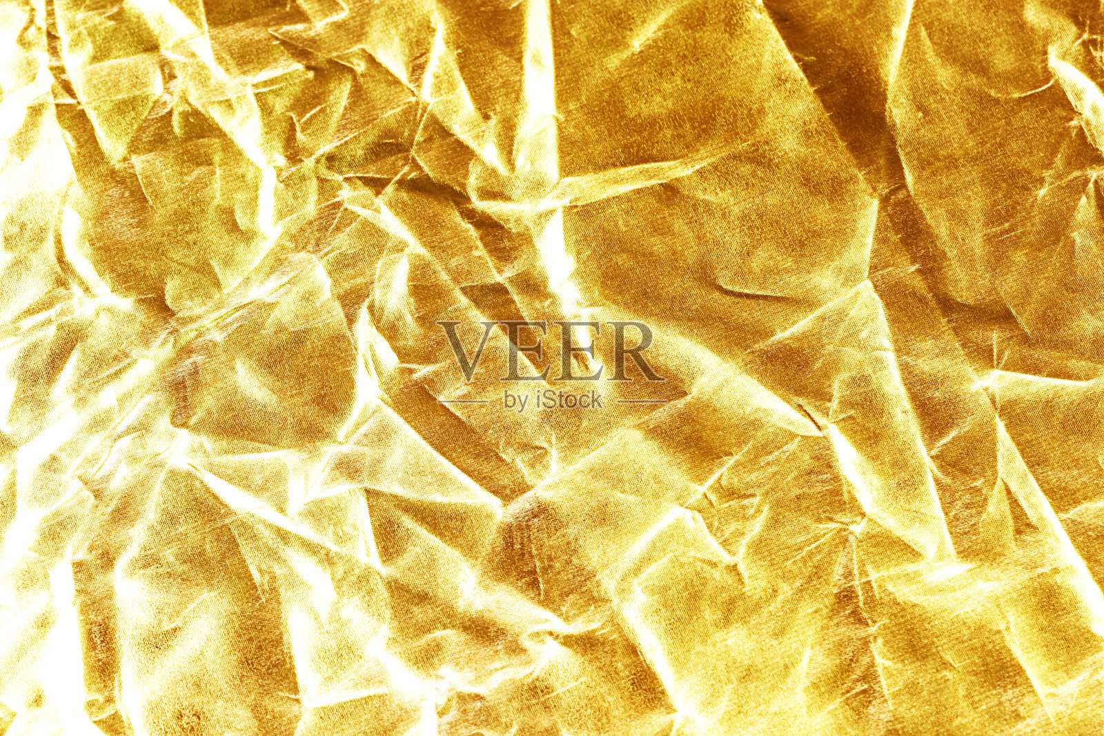 金色背景或纹理和阴影。黄金织物折痕照片摄影图片