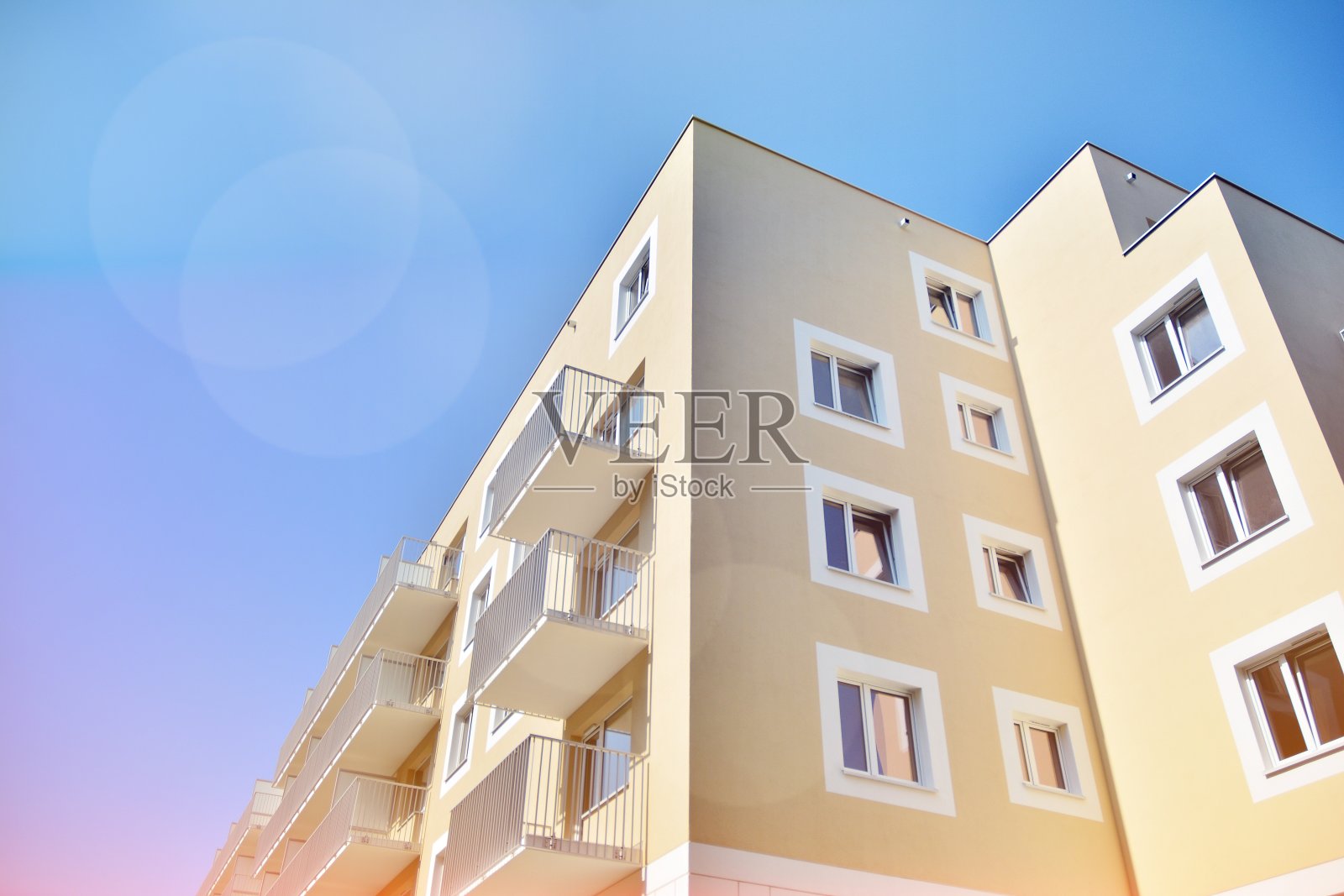 现代化的公寓大楼在一个晴朗的日子与蓝天。照片摄影图片