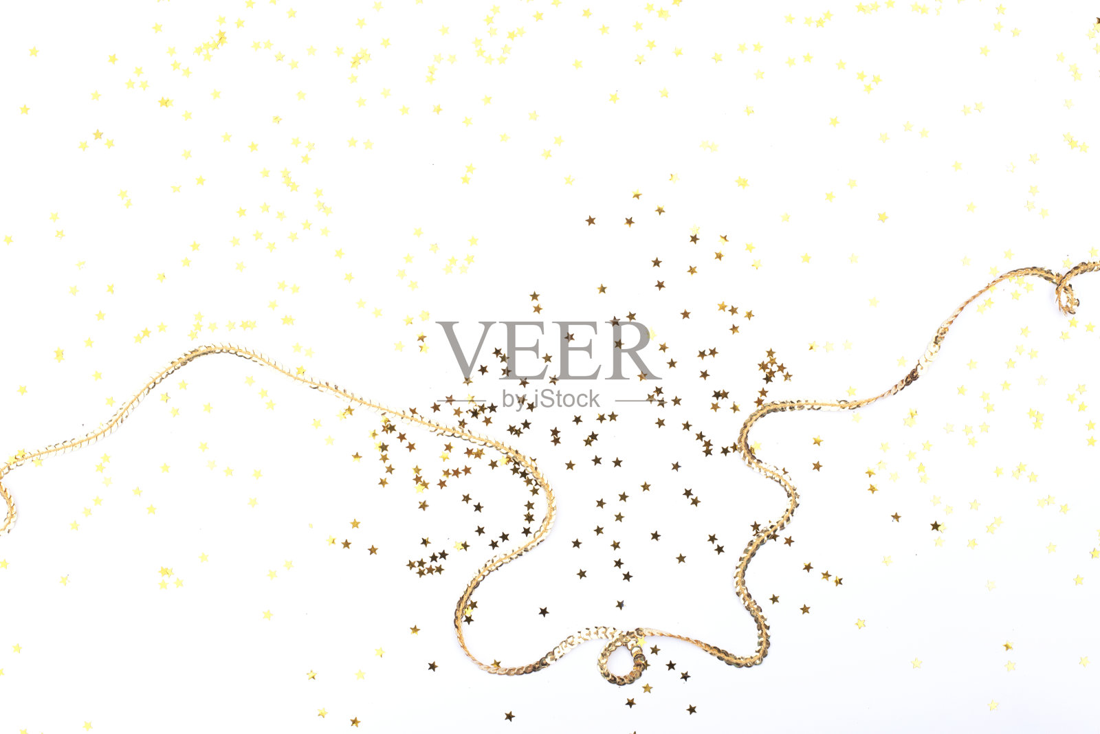 节日的白色背景与金色的星星和亮片。照片摄影图片