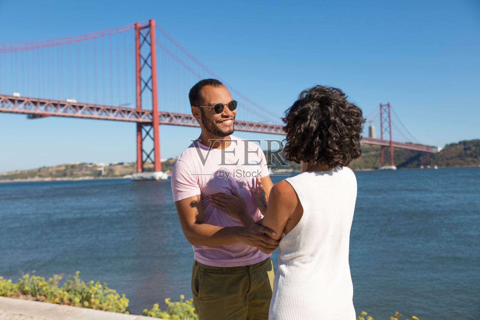 一对快乐的年轻夫妇在河边牵着手照片摄影图片
