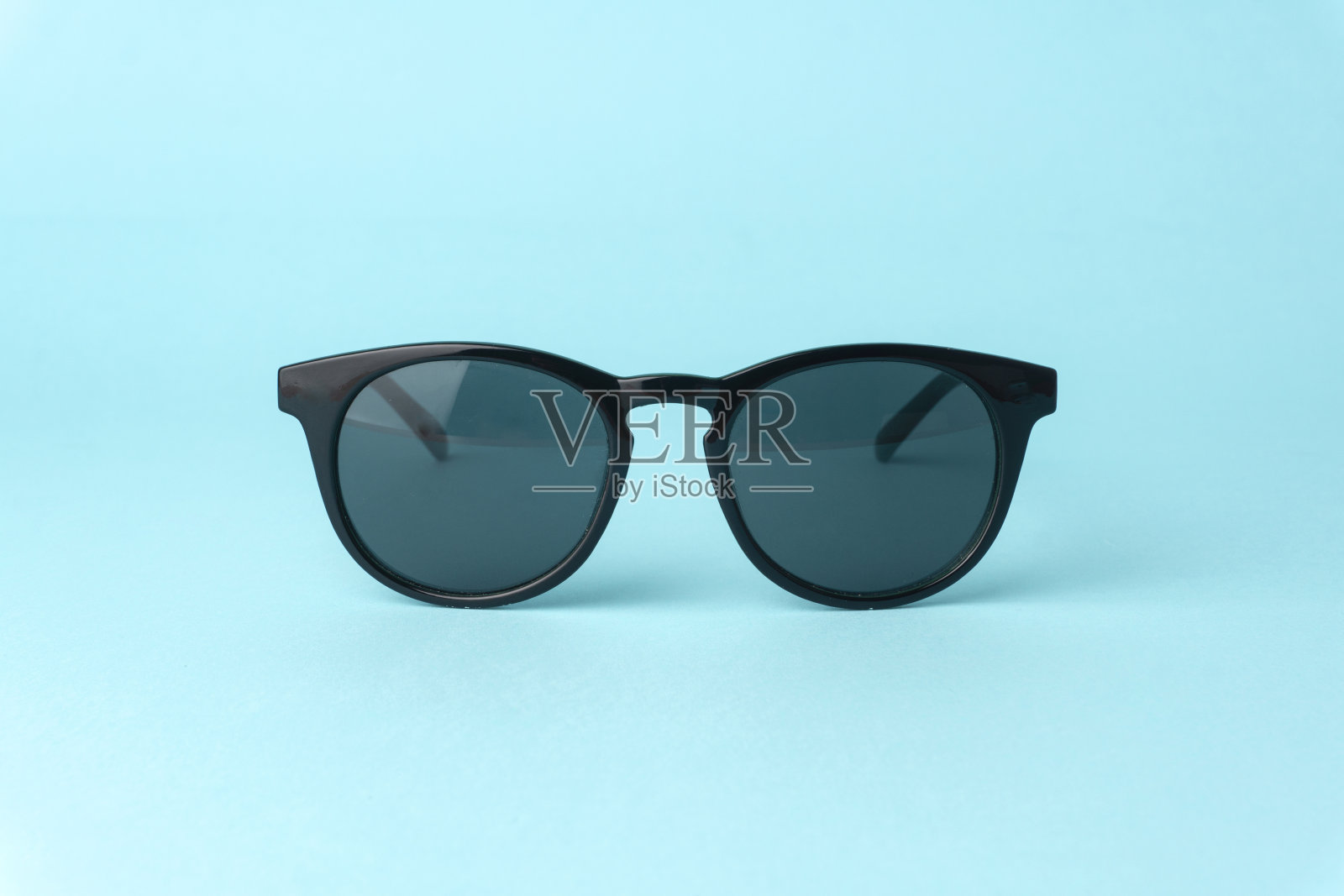 黑色复古太阳镜在一个明确的蓝色背景照片摄影图片